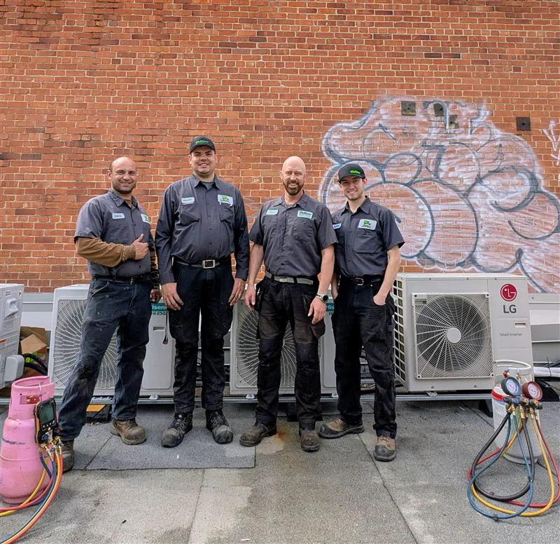 Four Welldone technicians with commercial HVAC equipment