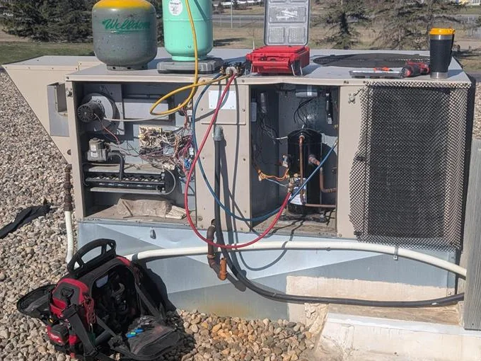 Commercial rooftop HVAC unit open for diagnostics